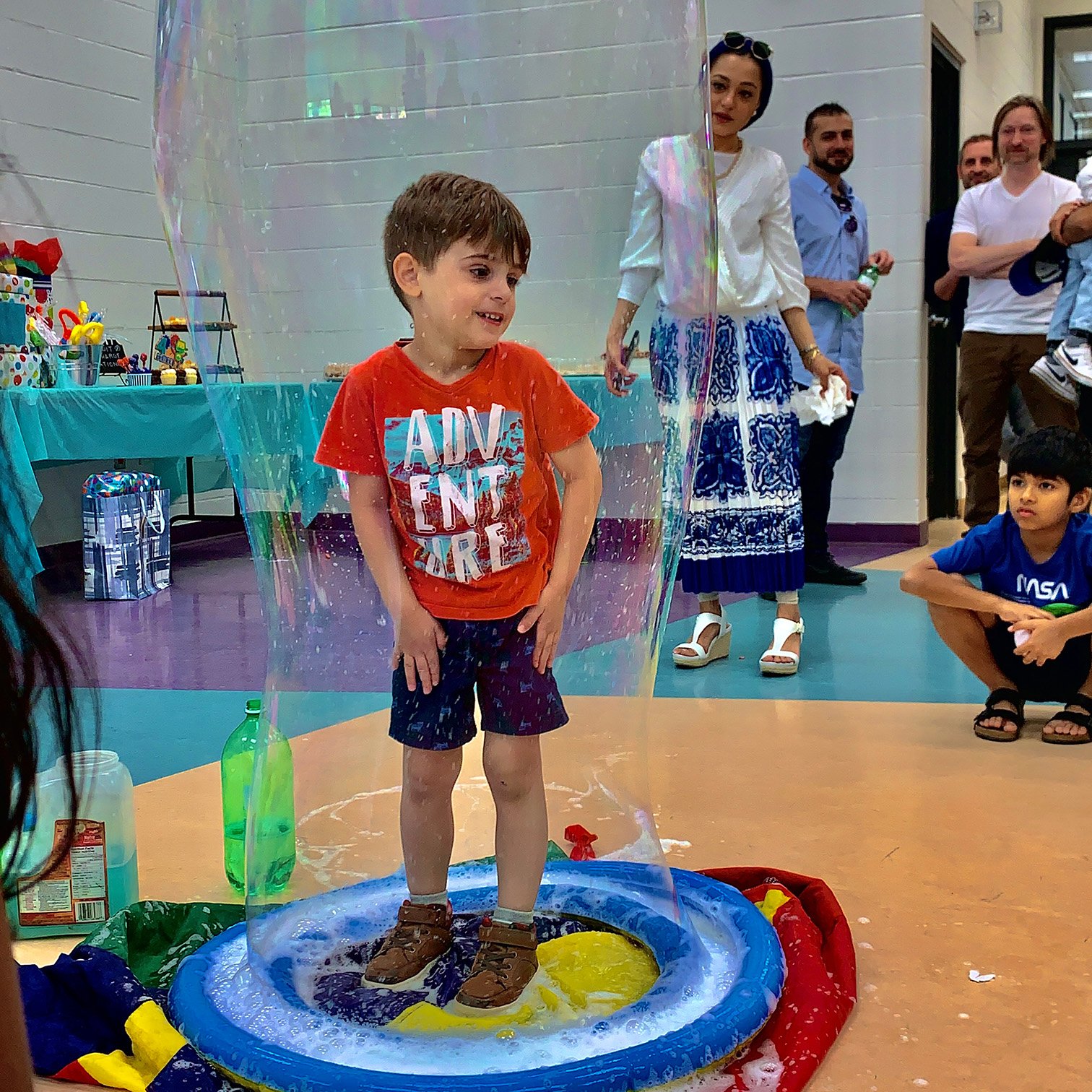Child participating in a giant bubble activity